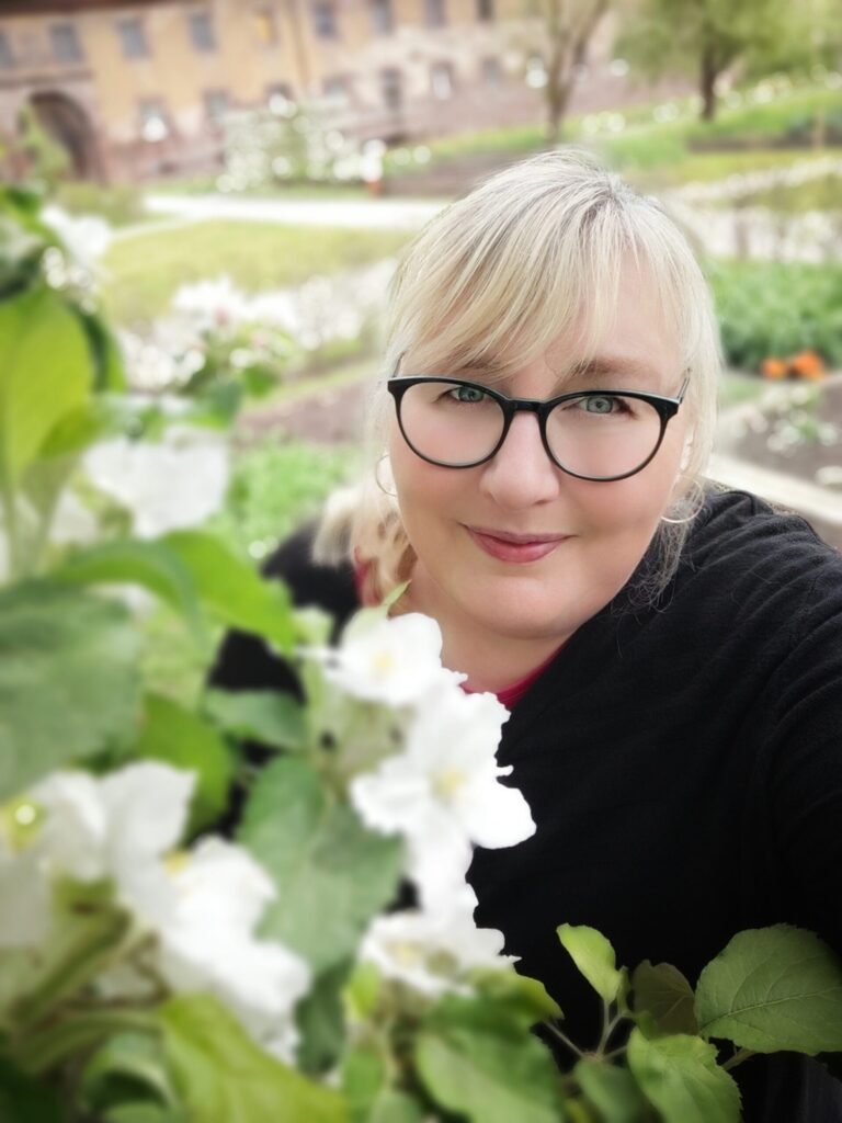 Gärtnerin, Pferdebesitzerin und virtuelle Assistentin in einem Garten mit Blumen